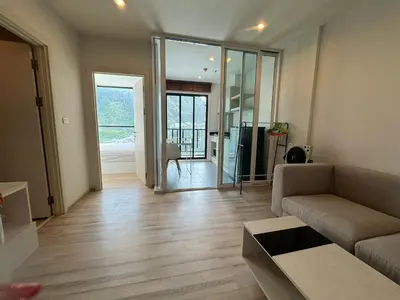 a living room with a couch and a table at The Base Height Phuket in Phuket Town