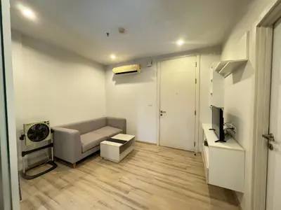 a living room with a couch and a television at The Base Height Phuket in Phuket Town
