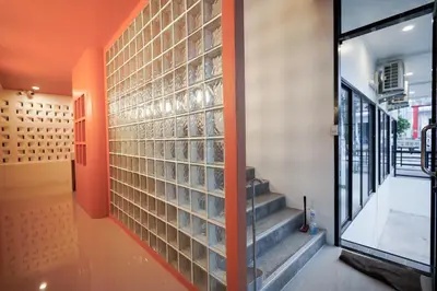 a hallway with glass blocks on the wall at Tiger Nest Stay in Ban Suan