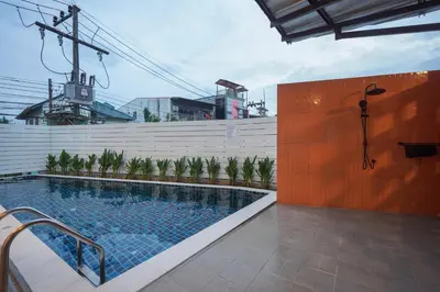 a swimming pool in the middle of a building at Tiger Nest Stay in Ban Suan