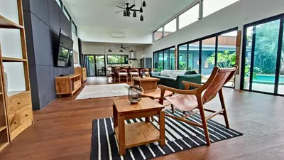 a living room with a couch and a table at Sarang Jati Mansion in Ban Saiyuan (1)