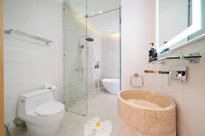 a bathroom with a toilet and a glass shower at Near Laguna 4 BR morden pool villa V9 in Ban Pak Lak