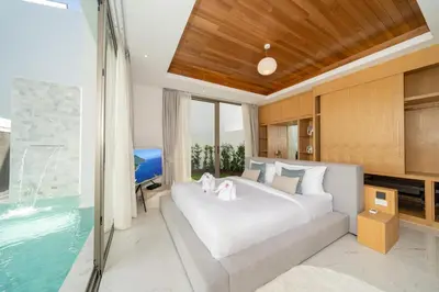 a bedroom with a large bed and a swimming pool at Near Laguna 4 BR morden pool villa V9 in Ban Pak Lak