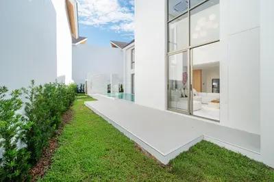an exterior view of a white house with a lawn at Near Laguna 4 BR morden pool villa V9 in Ban Pak Lak