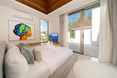 a living room with a white couch and a large window at Near Laguna 4 BR morden pool villa V9 in Ban Pak Lak