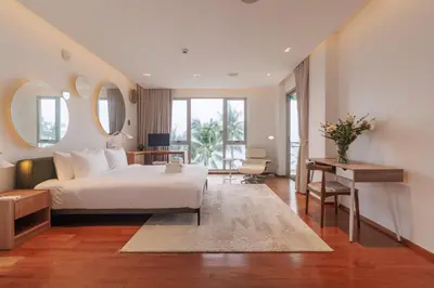 a bedroom with a bed and a desk and a table at ANGSANA Coastal Bliss Penthouse 3bds Apartment with pool in Laguna Phuket