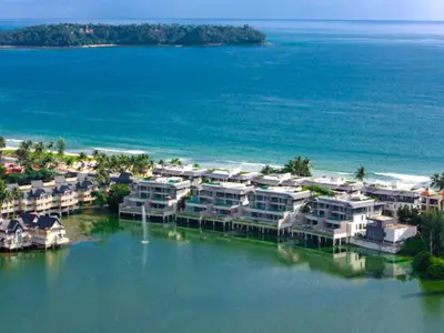 an aerial view of a beach with houses in the water at ANGSANA Coastal Bliss Penthouse 3bds Apartment with pool in Laguna Phuket
