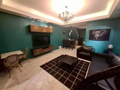 a living room with a couch and a tv at New Five Star Home- Patong Beach in Patong Beach
