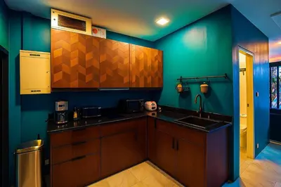 a kitchen with a sink and a blue wall at New Five Star Home- Patong Beach in Patong Beach