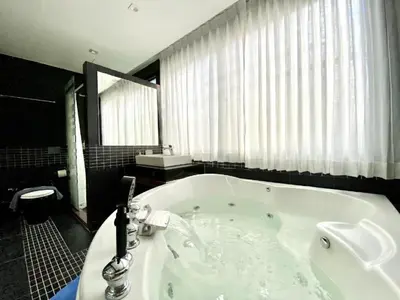 a bathroom with a large tub with a window at Studio Bangla Suite 304 in Patong Beach
