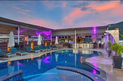 a pool at a hotel with chairs and umbrellas at Studio Bangla Suite 304 in Patong Beach