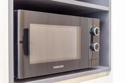 a microwave oven sitting on a wall at Ozone Modern in Laguna Phuket