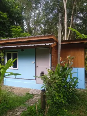 a tiny house with a blue and white exterior at Bang risskee home stay1 in Ko Yao Noi