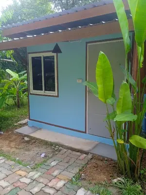 a small house with a blue exterior at Bang risskee home stay1 in Ko Yao Noi