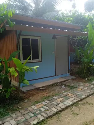 a small house with a blue exterior at Bang risskee home stay1 in Ko Yao Noi