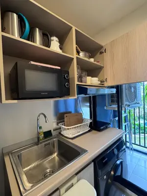 a small kitchen with a sink and a microwave at DCondo Kathu ใกล้หาดป่าตอง in Kathu