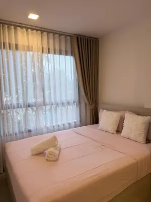 a bedroom with a large bed with a window at DCondo Kathu ใกล้หาดป่าตอง in Kathu