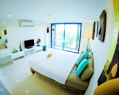 a bedroom with a large bed and a window at Seaview At Cape Panwa in Panwa Beach