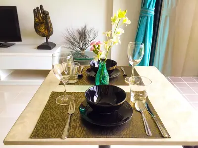 a table with plates and wine glasses on it at Seaview At Cape Panwa in Panwa Beach