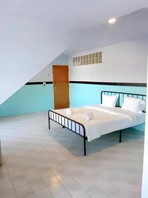 a bedroom with two beds in a room at XX Mitr Inn Phuket Island - Phuket Old Town in Phuket Town