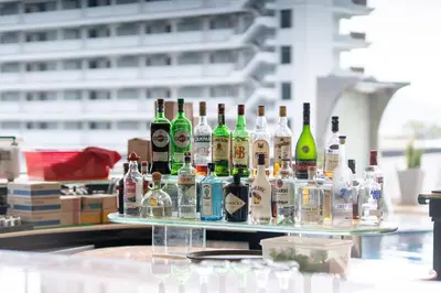 a group of bottles of alcohol sitting on a table at Absolutely Amazing Bangla 1BR Suite in Patong Beach