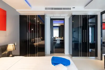 a bedroom with a bed with a blue towel on it at Absolutely Amazing Bangla 1BR Suite in Patong Beach