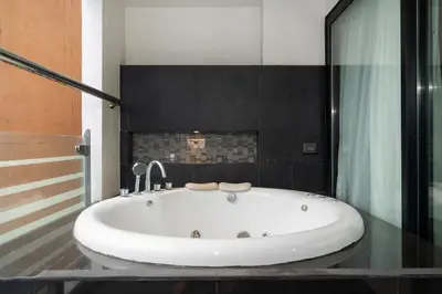 a white bath tub in a bathroom with a shower at Absolutely Amazing Bangla 1BR Suite in Patong Beach