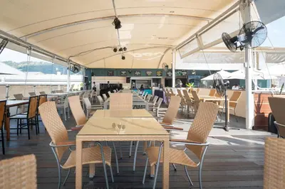 a dining area on a cruise ship with tables and chairs at Absolutely Amazing Bangla 1BR Suite in Patong Beach