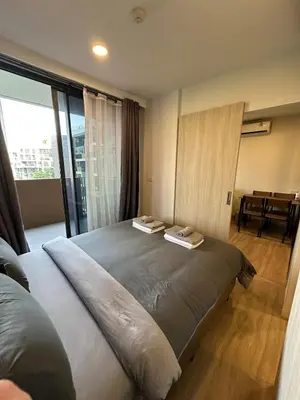 a bedroom with a large bed with two towels on it at Magnificent apartments in Laguna in Laguna Phuket
