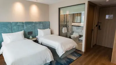 a hotel room with two beds and a bathroom at Laya Resort - Forest View Studio in Layan Beach