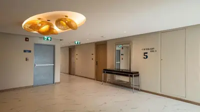 a hallway of a building with a lobby with a hallway at Laya Resort - Forest View Studio in Layan Beach