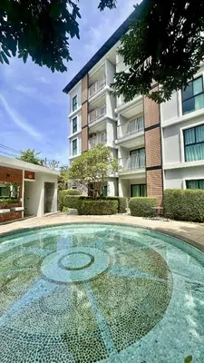 a swimming pool in front of a building at Title V - 1 br Bamboo Rawai Apartment in Karon Beach