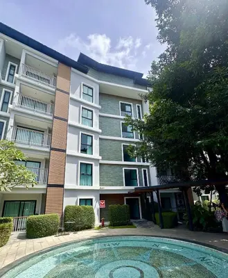 an apartment building with a pool in front of it at Title V - 1 br Bamboo Rawai Apartment in Karon Beach