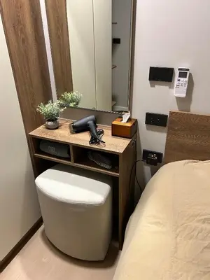 a bedroom with a vanity with a phone and a mirror at Flat near the beach with gym, pool, sauna and workspace in Ban Thalat Choeng Thale