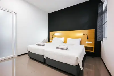 a bedroom with a large bed with white sheets at Vivace Hotel in Kamala Beach