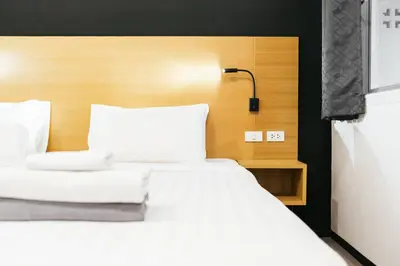 a bed with white sheets and pillows in a room at Vivace Hotel in Kamala Beach