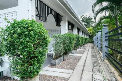 a building with a row of plants on the side of it at Vivace Hotel in Kamala Beach