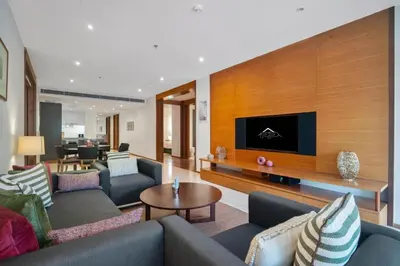 a large living room with couches and a tv at Stylish 2BR Resort Condo with Seaview Surin in Phuket Town