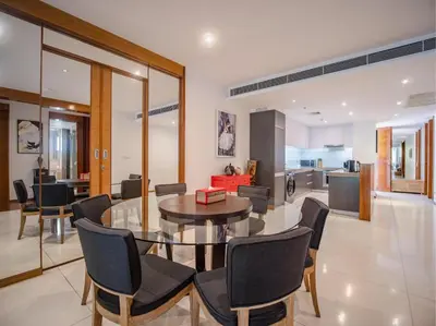 a dining room and kitchen with a table and chairs at Stylish 2BR Resort Condo with Seaview Surin in Phuket Town