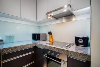 a kitchen with a counter top with a microwave at Stylish 2BR Resort Condo with Seaview Surin in Phuket Town