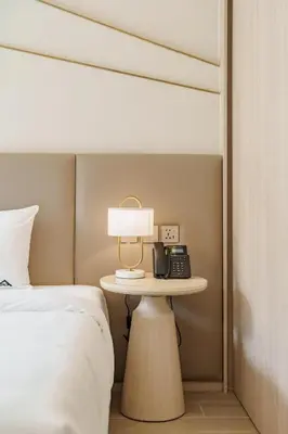 a bedroom with a bed and a phone on a table at Wyndham 2229 Naiton Beach Studio Forrest View in Phuket Town