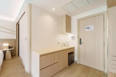 a kitchen with a counter and a door to a room at Wyndham 2229 Naiton Beach Studio Forrest View in Phuket Town