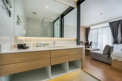 a bathroom with a sink and a large mirror at Wyndham 1221 Naiton Beach Studio Forrest View in Phuket Town