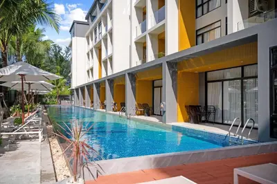 a swimming pool in front of a building at Wyndham 1221 Naiton Beach Studio Forrest View in Phuket Town