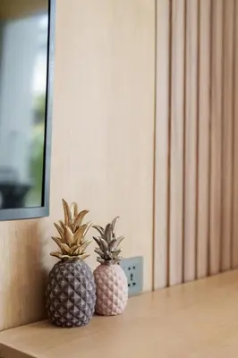 two pineapples sitting on a shelf in a room at Beachfront 1524 Wyndham Gardens Condo Naithon in Phuket Town