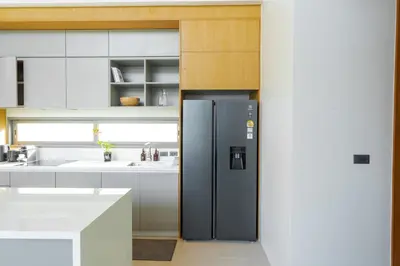 a kitchen with a refrigerator and a sink at Botanica Aroon Luxury Pool Villa 3 BR Lagoona Bangtao beach in Ban Pak Lak