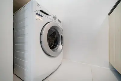 a washing machine in a white laundry room at Studio Apt Seaview Balcony - Oceana C63 in Kamala Beach
