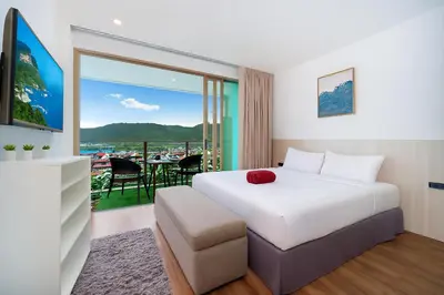 a hotel room with a bed and a balcony at Studio Apt Seaview Balcony - Oceana C63 in Kamala Beach