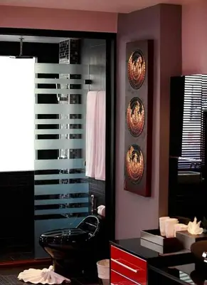 a bathroom with a black toilet and a mirror at Bangla Jacuzzi Suite 212 in Patong Beach