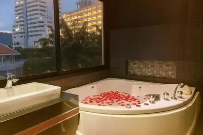a bathroom with a tub with red hearts on it at Bangla Jacuzzi Suite 212 in Patong Beach